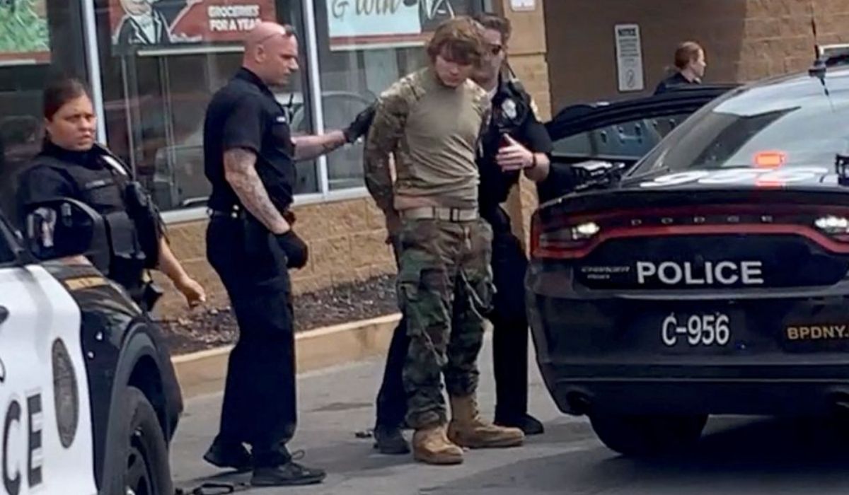 A man is detained following a mass shooting in the parking lot of TOPS supermarket
